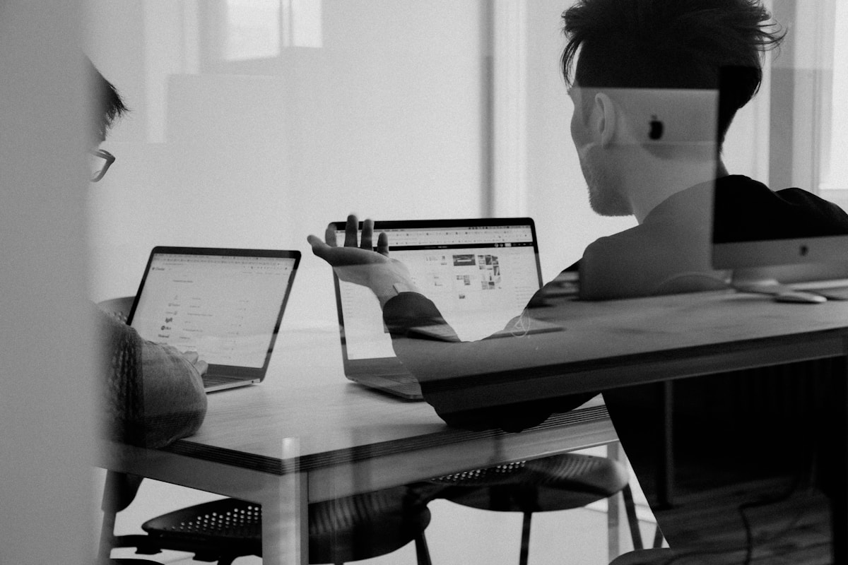 Client and EduSpark Lab team reviewing courseware prototypes on a large monitor.
