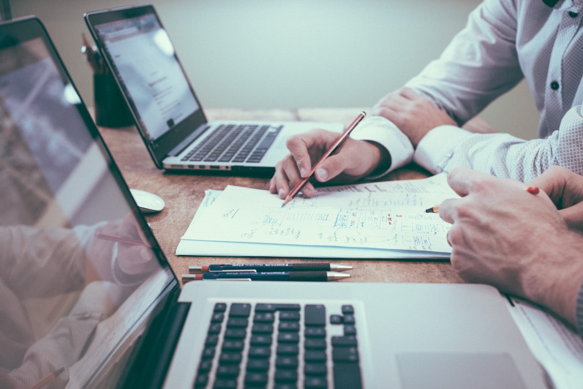 Content localization desk with bilingual source files and human-reviewed translation notes.